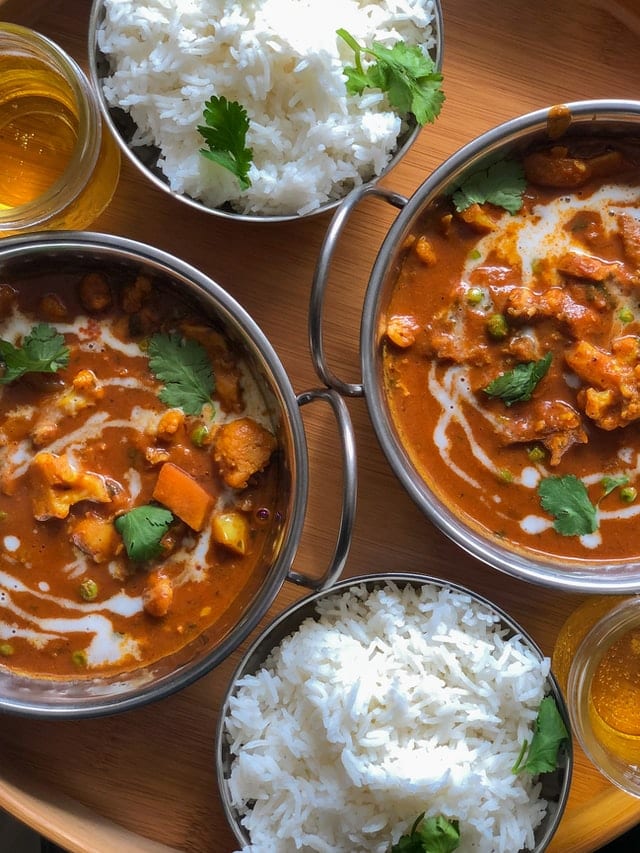 Bowls of spicy and fragrant Indian curry served together with aromatic Briyani rice, a perfect gourmet delight on a Asian luxury travel